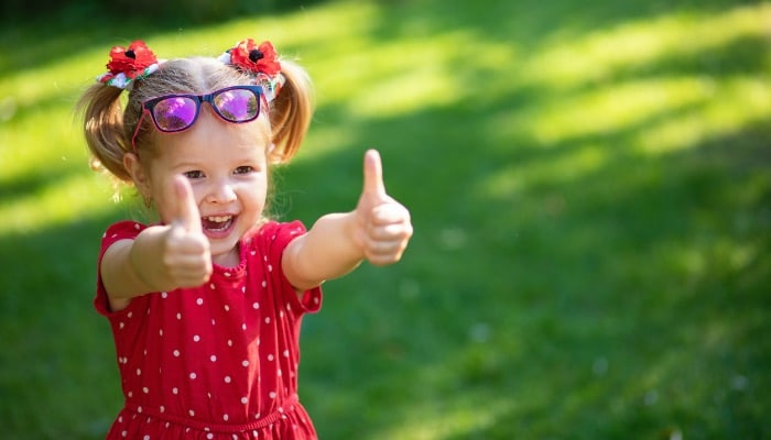 Child In Red Dress In Yard Thumbs Up