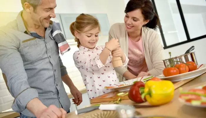 parents with child cooking together